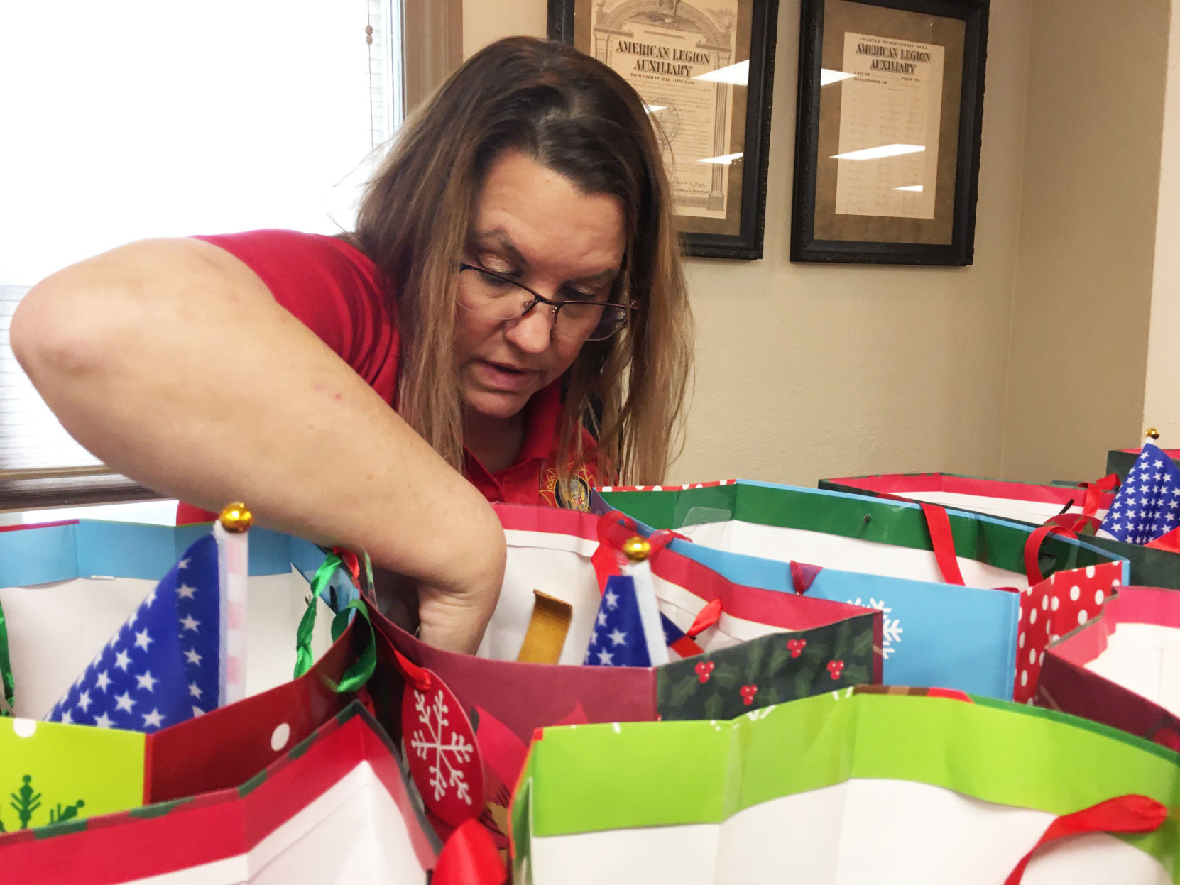 Kim McWilliams checks on gift bags being prepared for veterans home residents